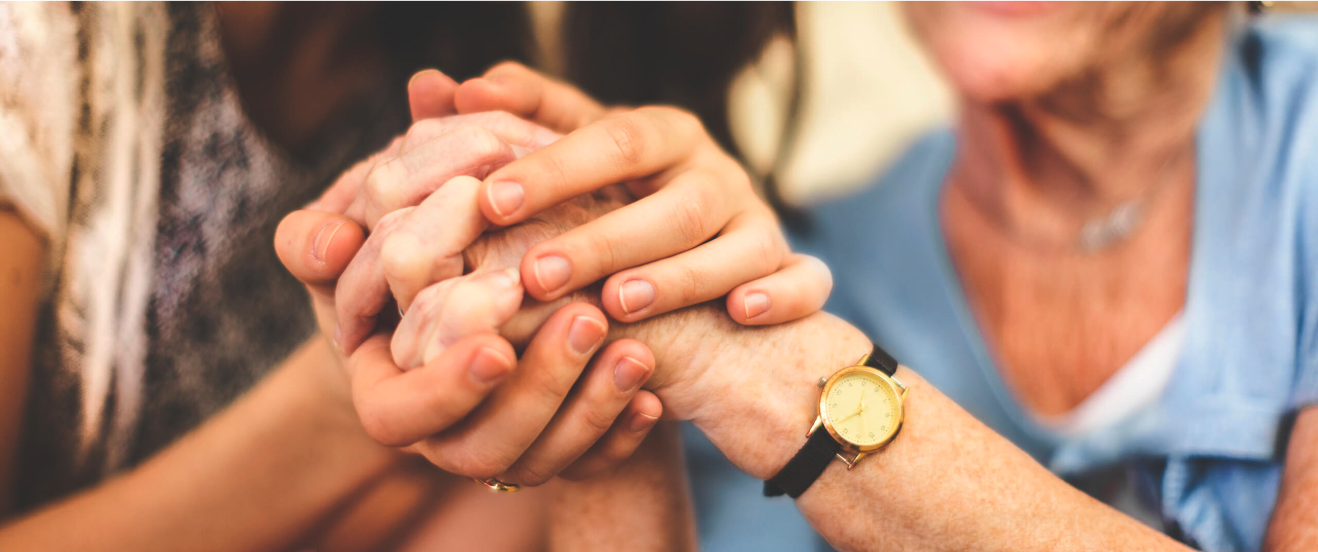 holding senior woman's hands