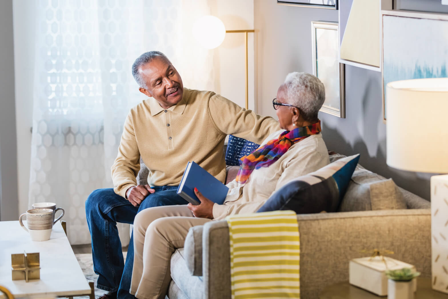 Senior couple talking on couch